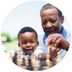 Grandparent & grandchild playing chess